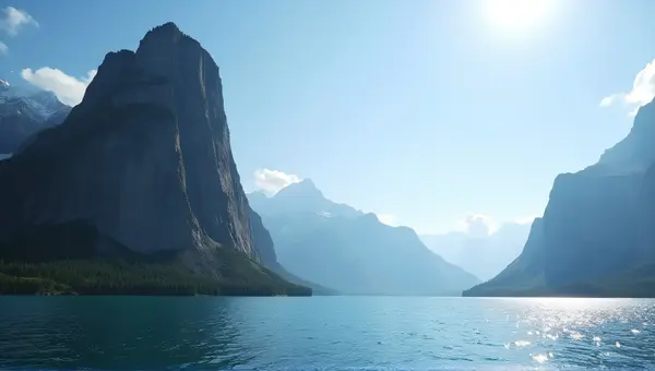 Rocky Peak Near Shimmering Lake Under Clear Sky