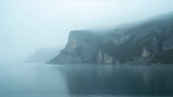 Rocky Ridge With Reflective Reservoir In Fog