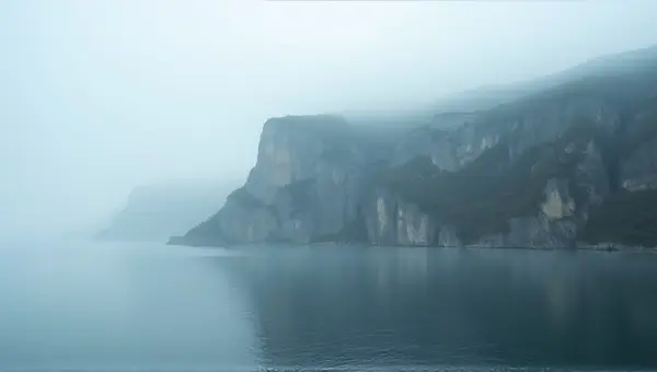 Rocky Ridge With Reflective Reservoir In Fog