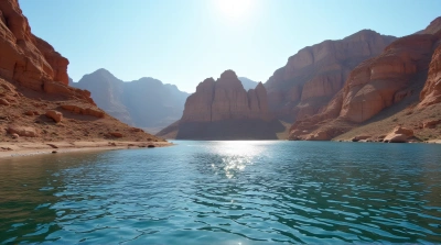 Rugged Cliffs Beside Shimmering Lake Under Sunlight