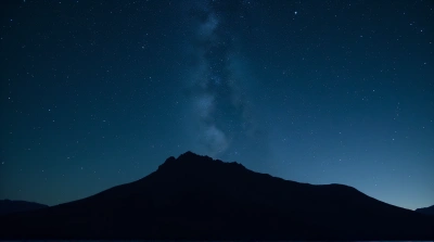 Rugged Mountain Ridge Under Starry Night Sky