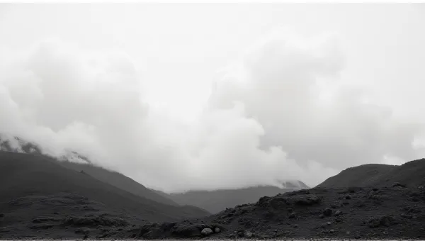 Rugged Terrain Under Pale Vapor Formations