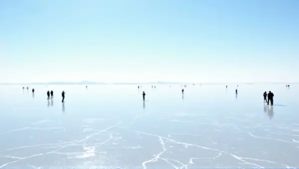 Scattered Individuals On Reflective Ice Plain Under Sunlight