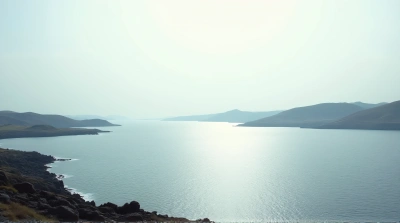 Shimmering Water Stretching Past Rocky Shores And Hills