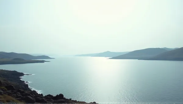 Shimmering Water Stretching Past Rocky Shores And Hills