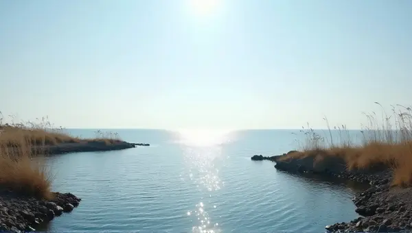 Shimmering Water Surface Near Rocky Shoreline