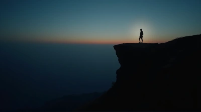 Silhouette At Precipice With Expansive Horizon View