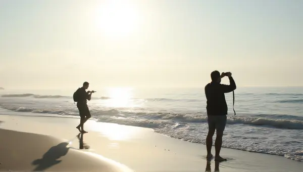Silhouetted Figures Along Ocean Shoreline Horizon