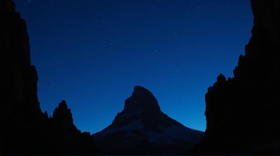 Silhouetted Rugged Peak Against Indigo Sky