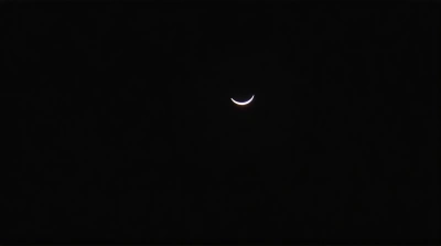 Slender Curved Crescent Silhouette In Dark Sky