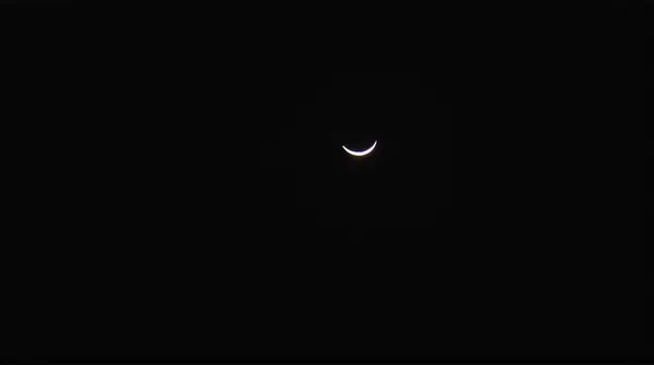 Slender Curved Crescent Silhouette In Dark Sky
