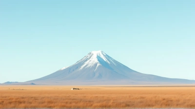 Snow-Capped Summit Above Dry Golden Grassland
