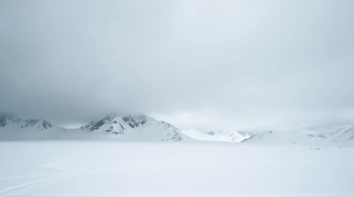 Snowy Mountain Range Beneath Cloudy Sky