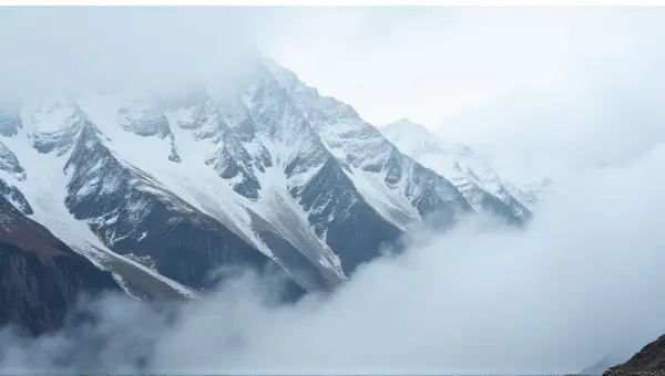 Snowy Mountain Slopes Above Misty Valley