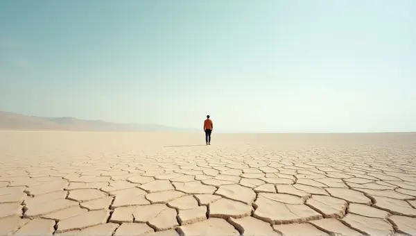 Solitary Person On Cracked Earth Under Clear Sky