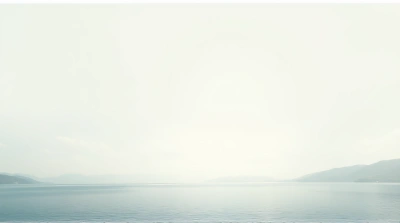 Still Lake With Soft Light And Distant Hills