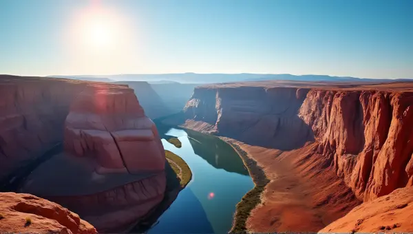 Sunlit Red Cliffs With Winding River Reflections