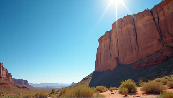 Sunlit Rugged Cliff Face Against Clear Blue Sky