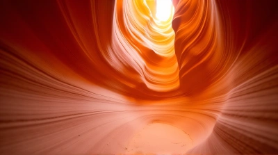 Sunlit Sandstone Passage With Layered Striations