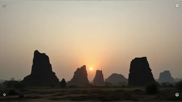 Sunrise Behind Towering Stone Pillars
