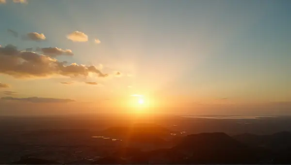 Sunset Sky With Warm Light And Scattered Clouds