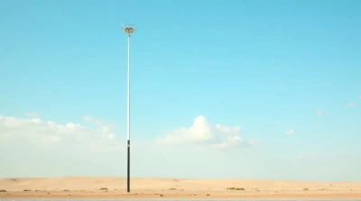 Tall Metal Pole On Dry Earth With Clear Sky