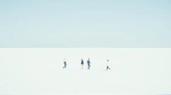 Three individuals moving diagonally across a wide white landscape under clear blue sky.