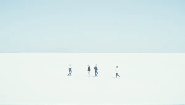 Three Figures Crossing Expansive White Landscape