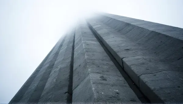 Towering Gray Facade Against Overcast Sky