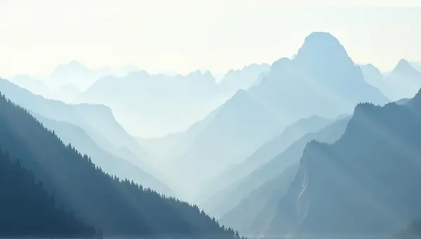 Towering Peaks Shrouded In Mist Under Pale Sky