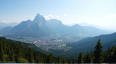 Town Near Dense Woodland With Towering Peaks