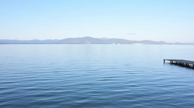 Tranquil Lake Scene With Wooden Pier And Hills