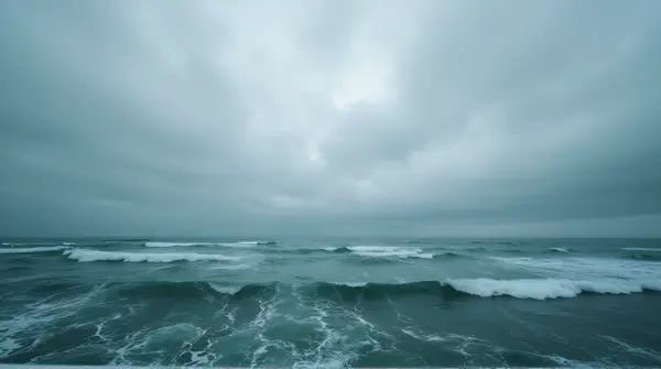 Turbulent Ocean Waters Beneath Layered Gray Sky