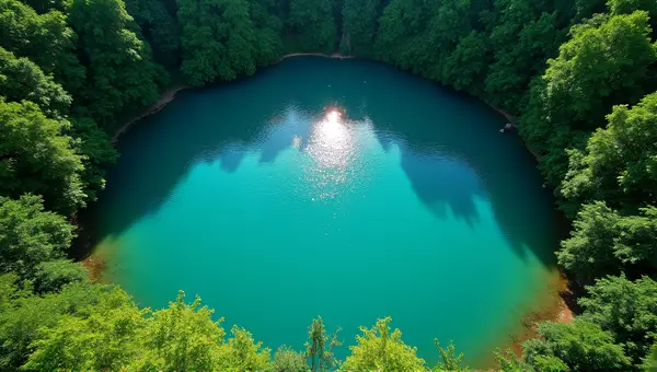 Turquoise Lake Surrounded By Lush Greenery Midday