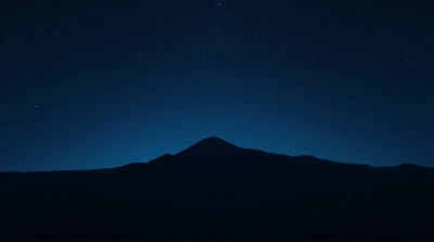 Twinkling Sky Above Shadowy Ridge Landscape