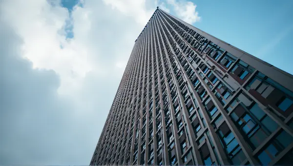 Upward Perspective Of Ornate Facade And Clouds