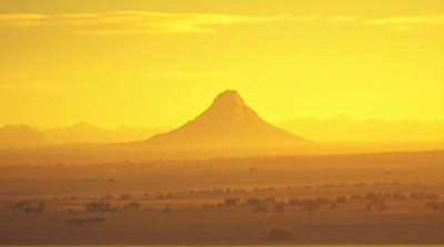 Vast Plain With Towering Peak Under Yellow Sky