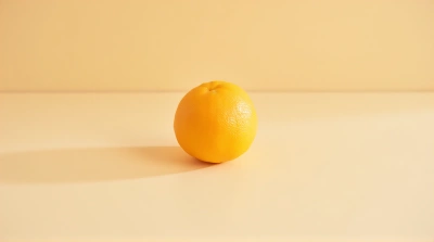 Vibrant Citrus Sphere On Smooth Tabletop