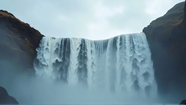 Waterfalls Flowing Down Cliff Under Cloudy Sky