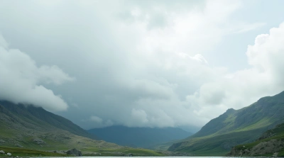 White Clouds Over Slate Gray And Emerald Hills