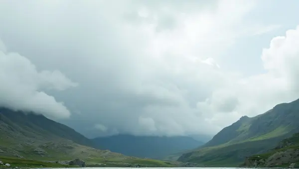 White Clouds Over Slate Gray And Emerald Hills