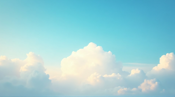 Soft white cumulus clouds scattered in a vibrant cerulean sky with warm golden sunlight