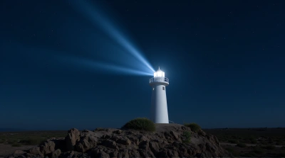 White Light Tower On Rocky Promontory At Night
