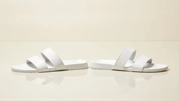 White Sandals Pair On Smooth Surface Top View
