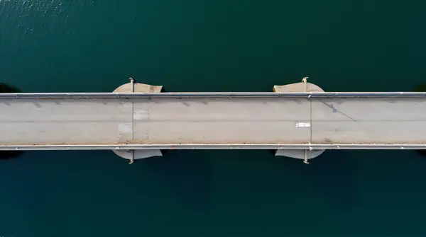 Wide Gray Bridge Crossing Calm Waterway