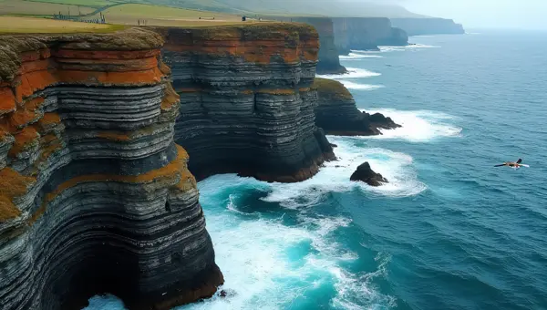Aerial Coastal Cliff Over Waves with Seabirds