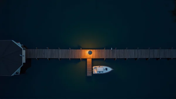 Aerial Night Dock Reflection Over Dark Water