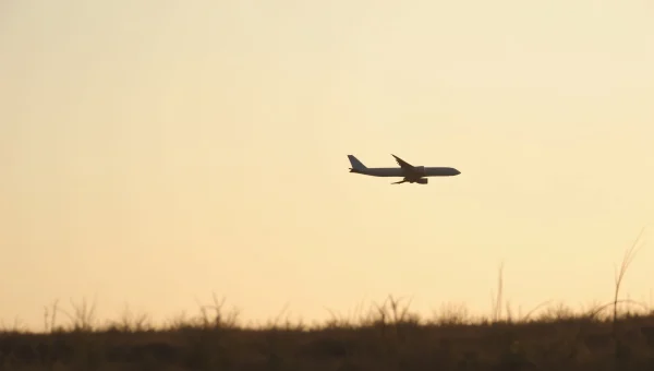 Airplane Silhouette Against Dusk Sky