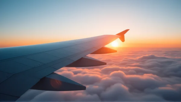 Airplane Wing Close-Up Through Sunrise Clouds