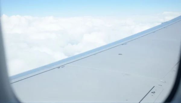 Airplane Wing View From Window Over Clouds